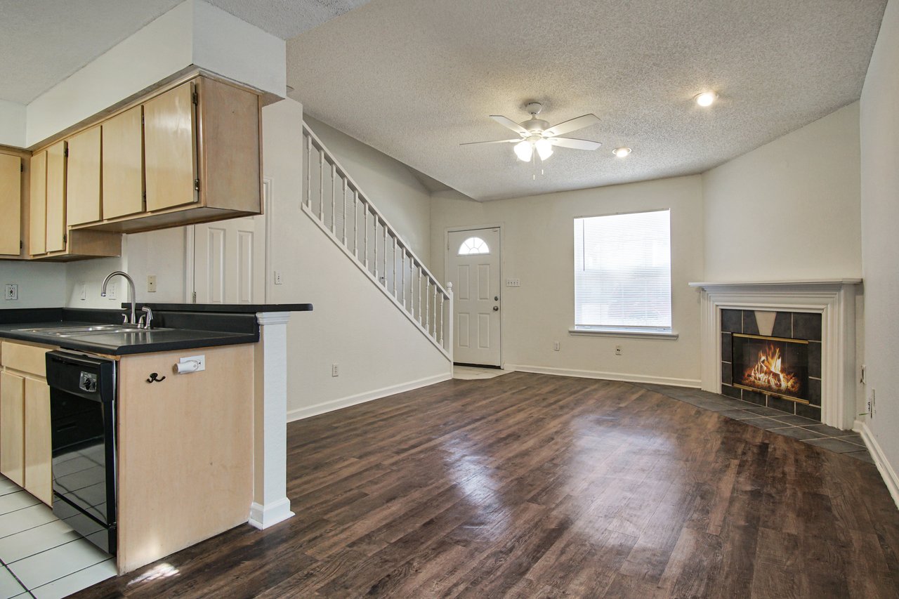 A cozy kitchen featuring a stove and a fireplace, creating a warm and inviting atmosphere for cooking and gathering.