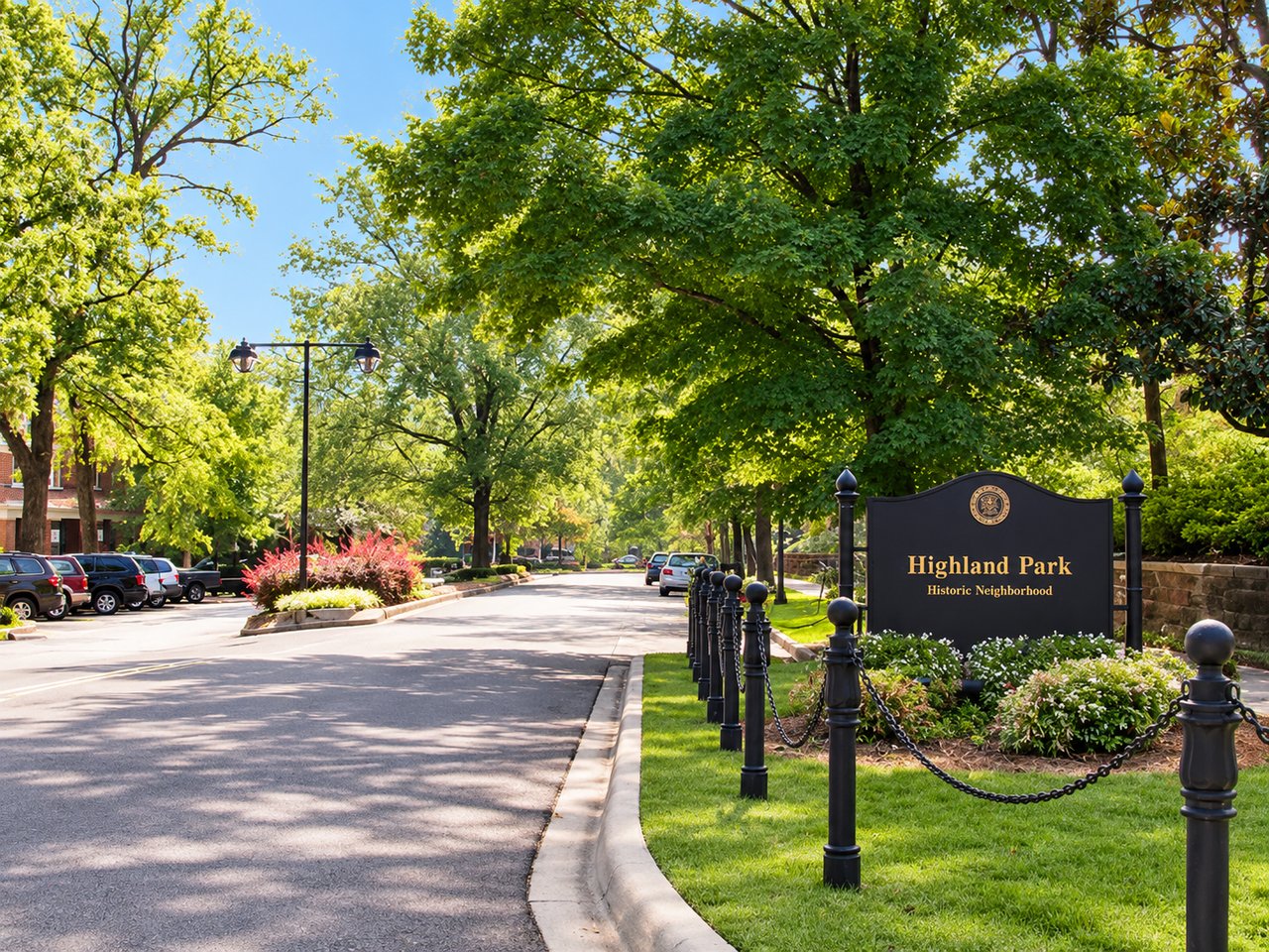 Highland Park Historic Neighborhood sign beside a leafy, tree-lined street.