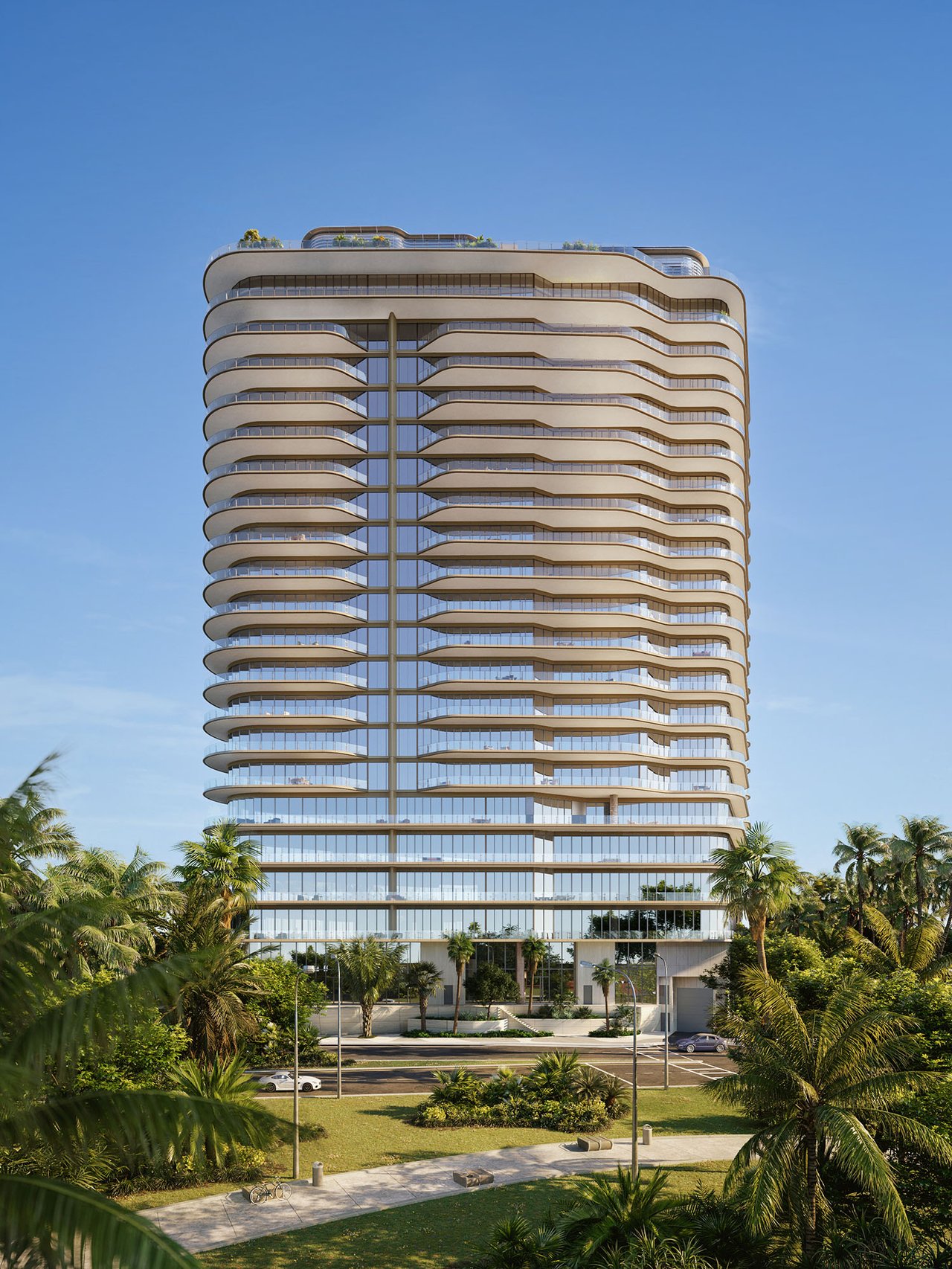 Four Seasons Residences Coconut Grove tower with curved balconies, glass facade, and palm-lined grounds.