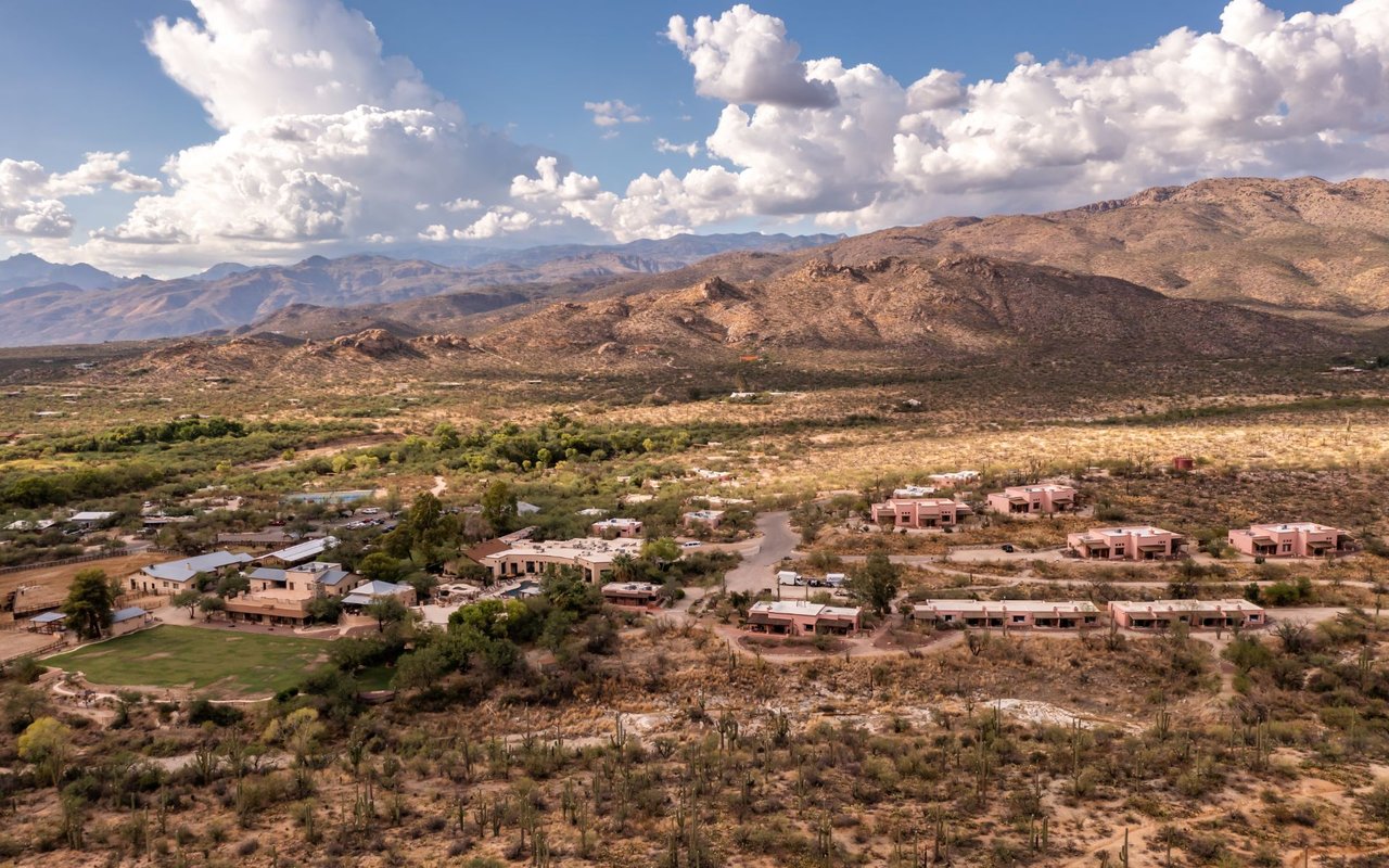 Desert homes and scrubland spread beneath rugged mountains in Tanque Verde and Sabino Canyon.