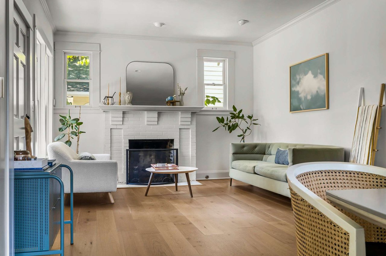 Living room with painted brick fireplace at 1500 Northwood Rd, Pemberton Heights, Austin.