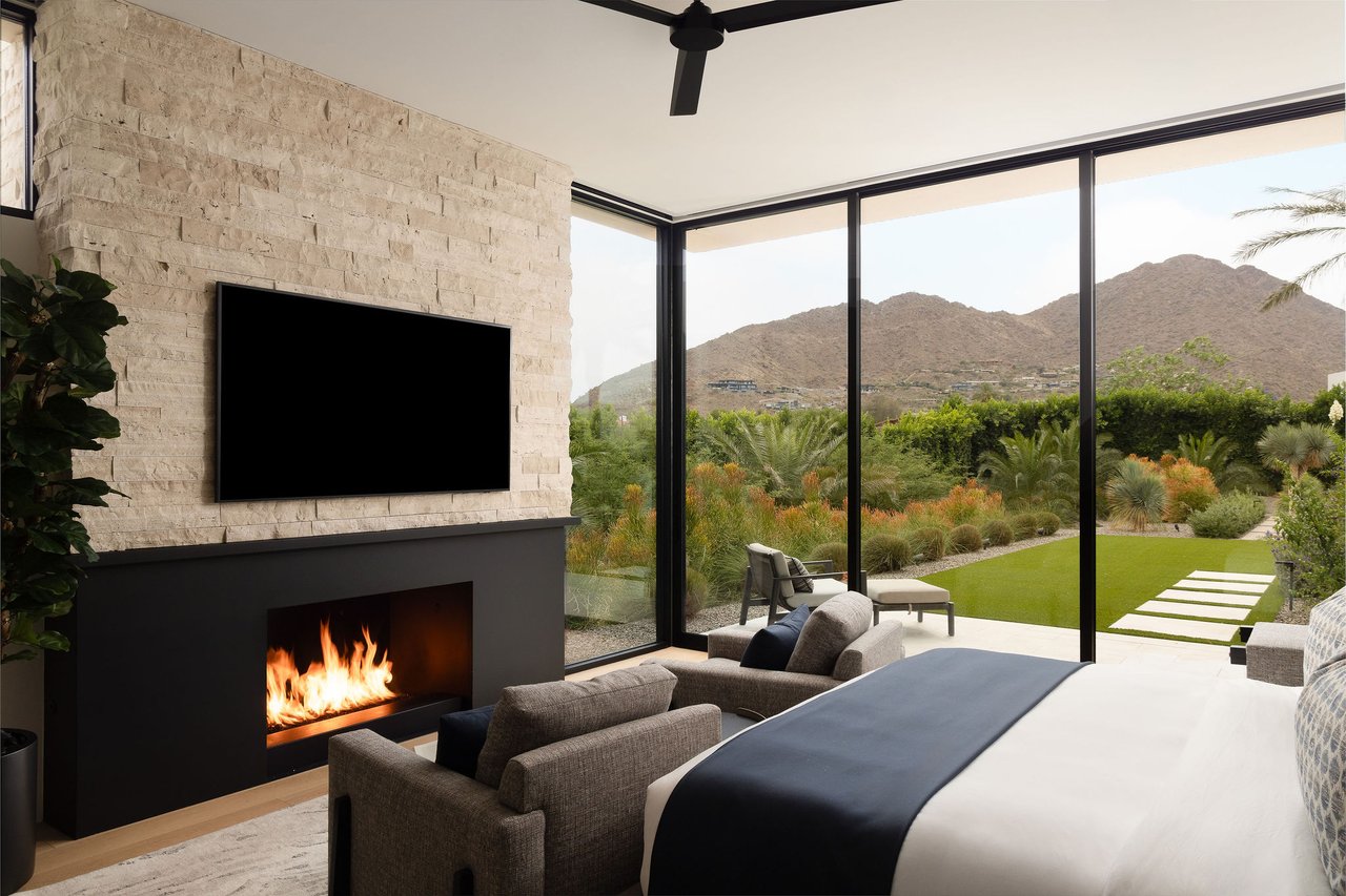 Modern luxury home in Paradise Valley with resort-style backyard, pool, fire feature, and contemporary architecture at sunset.