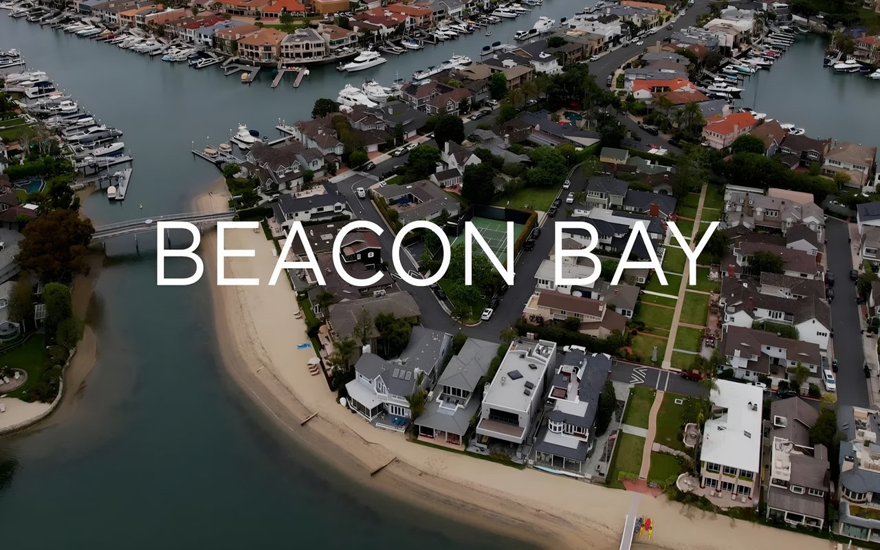 An aerial view of the Beacon Bay neighborhood with boats docked in the water, houses along the shore.