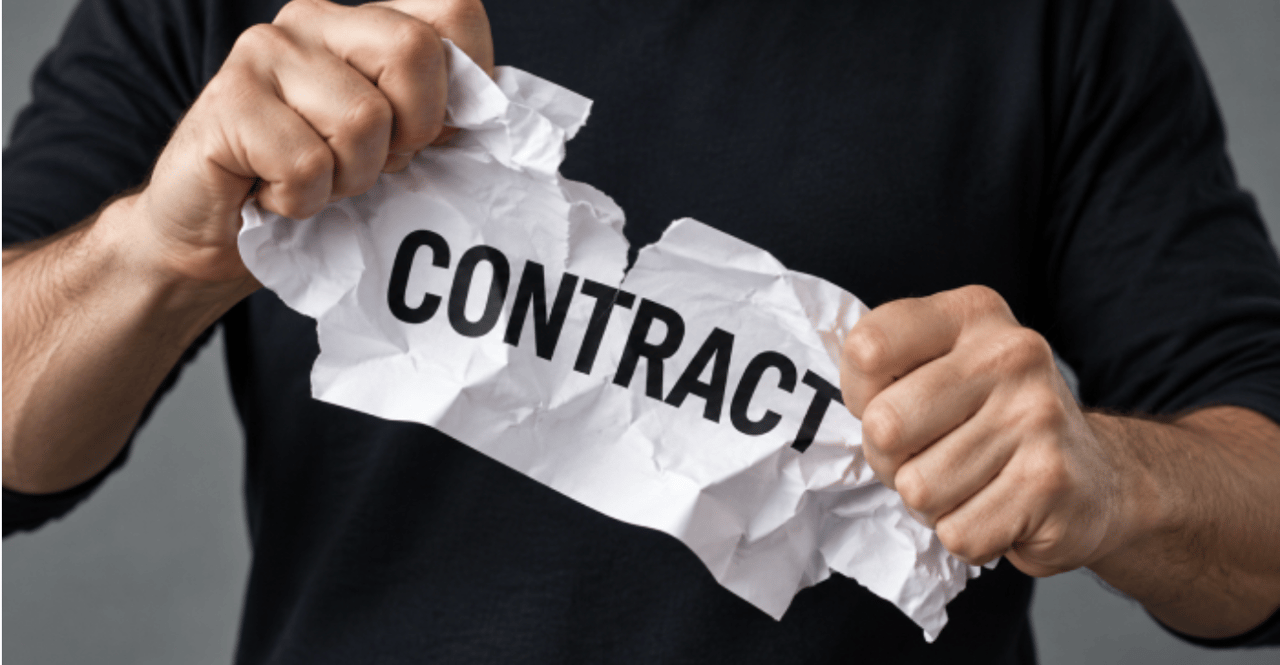 Hands tearing a crumpled paper labeled “CONTRACT.”