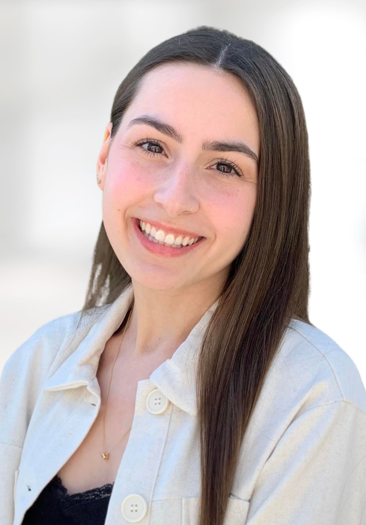 Rylie Palladino smiling in a light-colored jacket, with long straight dark hair.