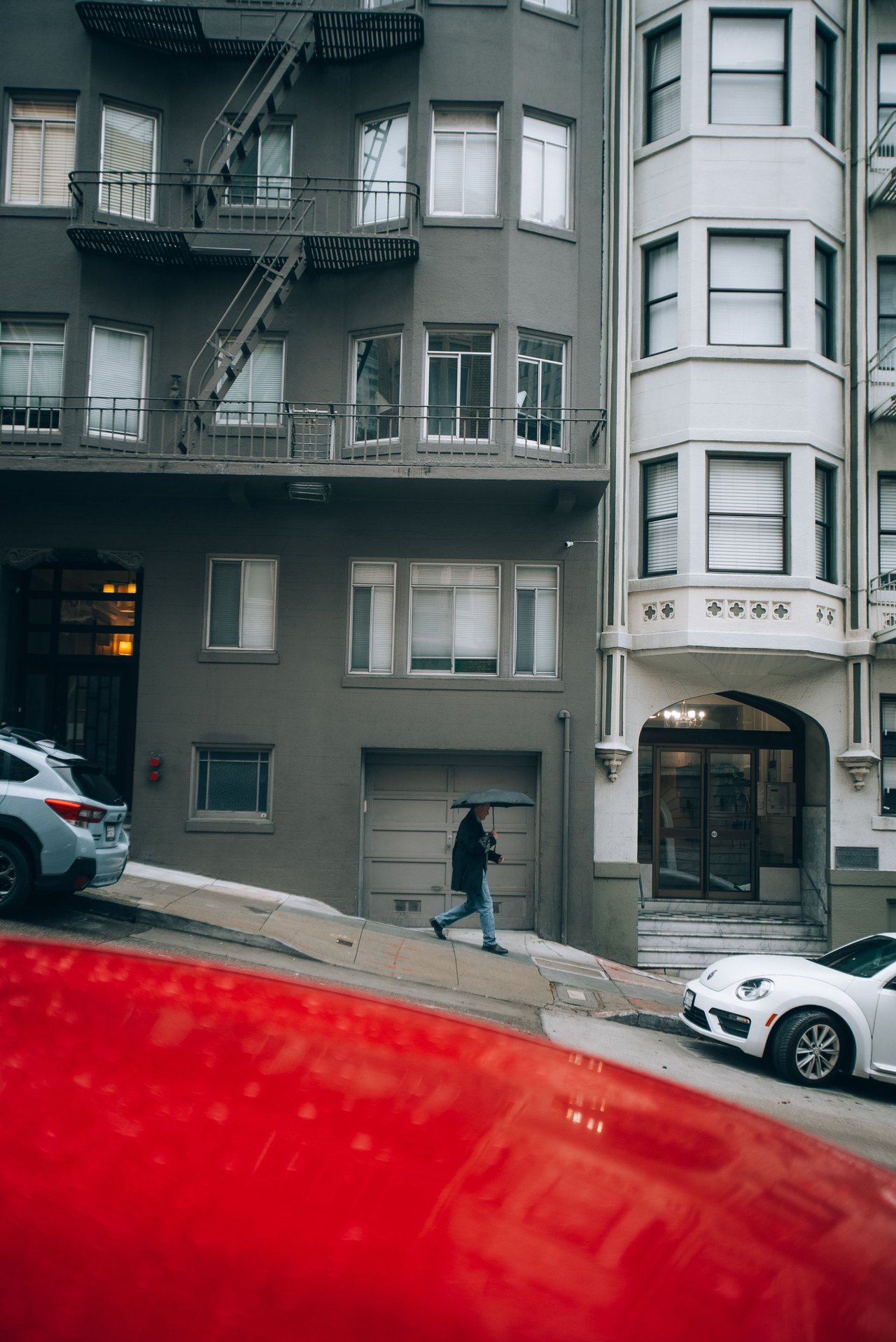 Man with an umbrella walking on San Francico's hills