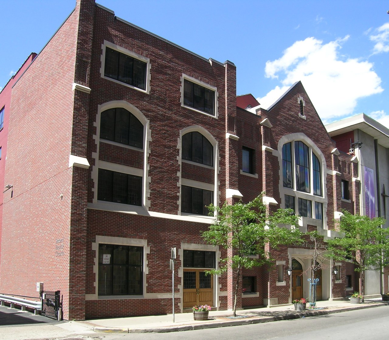 Second Baptist Church’s red-brick exterior with arched windows and cream-colored trim.