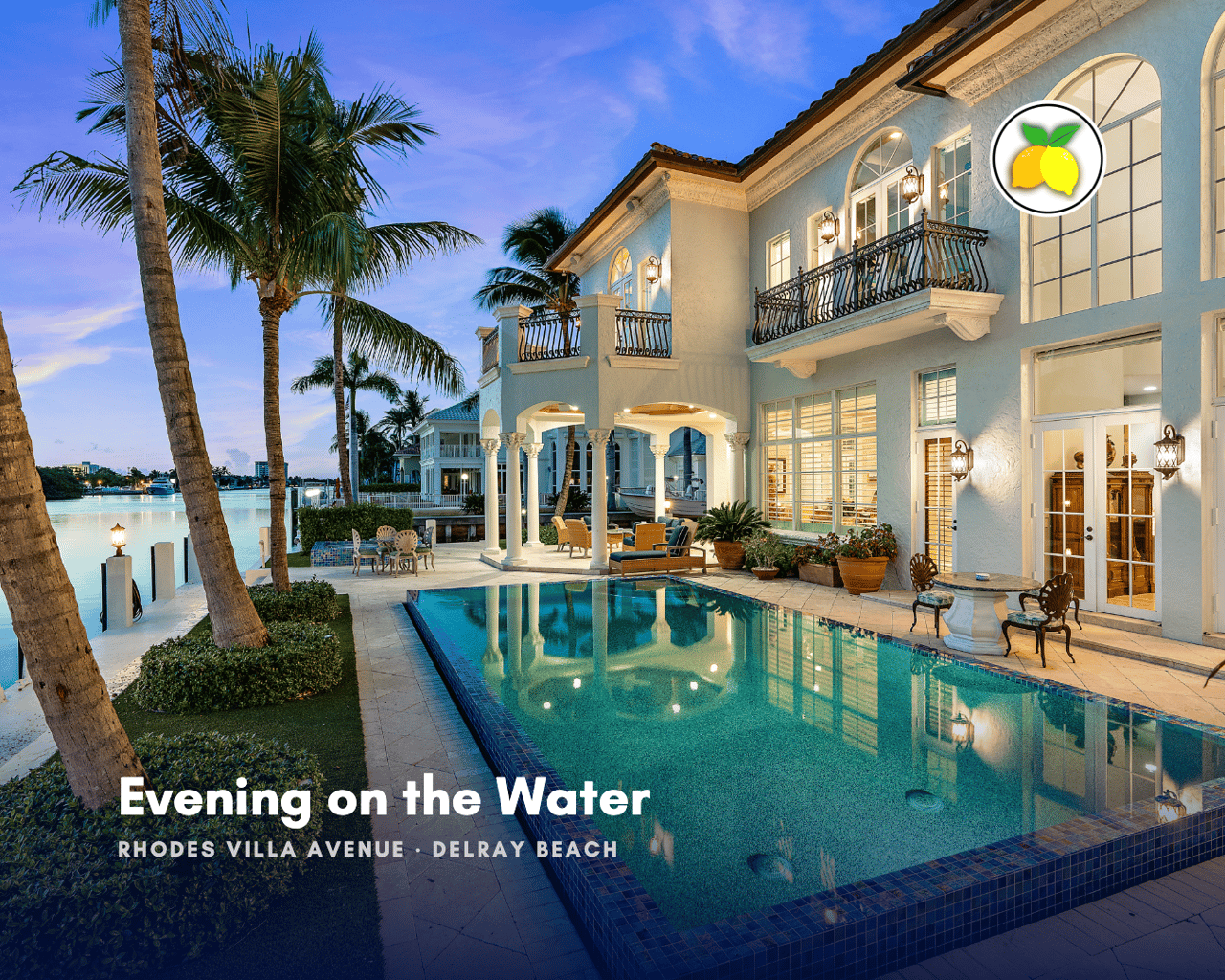 Twilight view of a Mediterranean-style waterfront estate in Delray Beach, Florida, with wrought-iron balconies, a columned loggia, and a glass-tile pool beside the Intracoastal Waterway