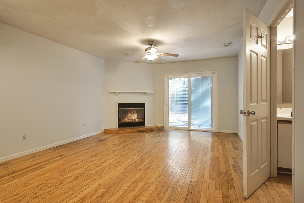 A cozy room featuring a fireplace and elegant hardwood floors, creating a warm and inviting atmosphere.