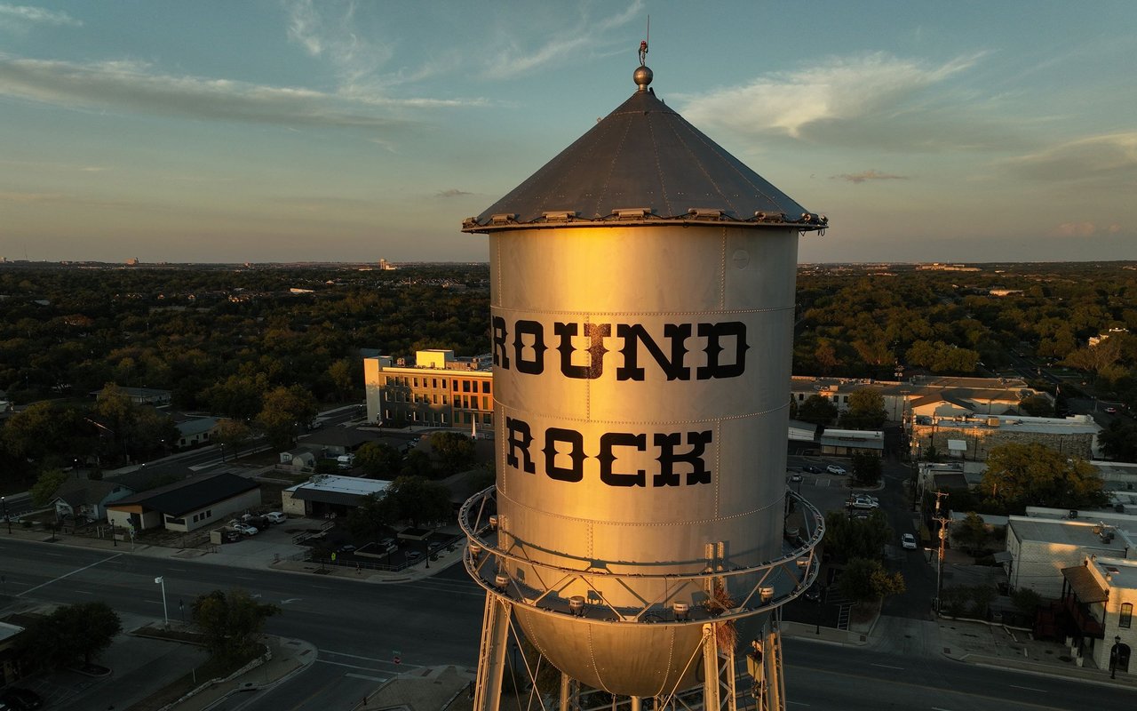 Round Rock water tower above the city at golden hour.