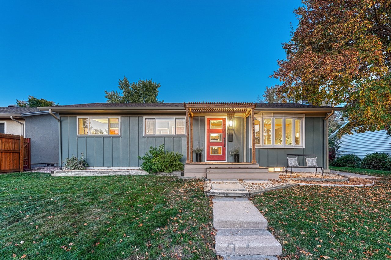 Twilight front view of 2845 N Institute, Colorado Springs, a ranch home with a pergola entry and red front door