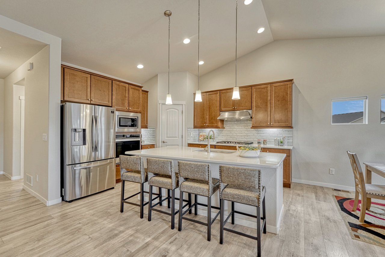Kitchen with island seating, French-door refrigerator, built-in wall oven and microwave
