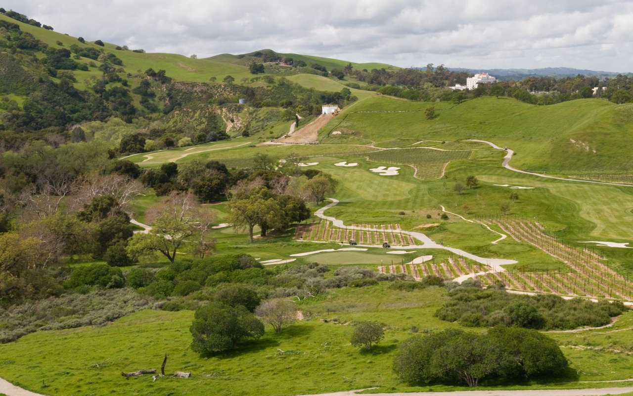 Livermore golf course winding through green hills and vineyard rows.