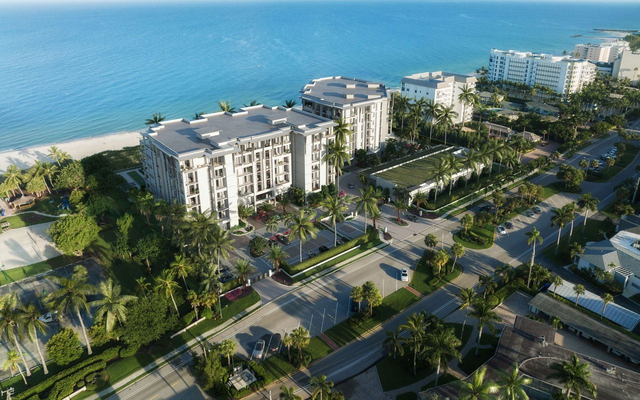 Aerial rendering of Rosewood Residences Naples beside the Gulf, with white residences and palm-lined grounds.
