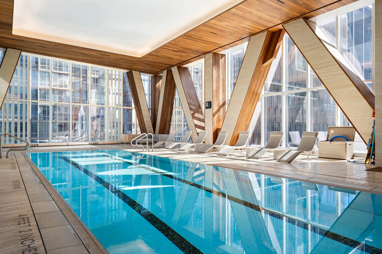 Luxury building amenities in Manhattan including a 24-hour doorman, concierge, indoor pool, fitness center, spa, valet parking, landscaped gardens, and resident lounge.
