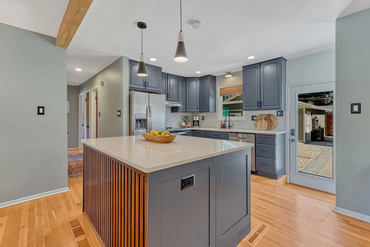 Kitchen island with a slatted wood panel and a back door leading to the patio