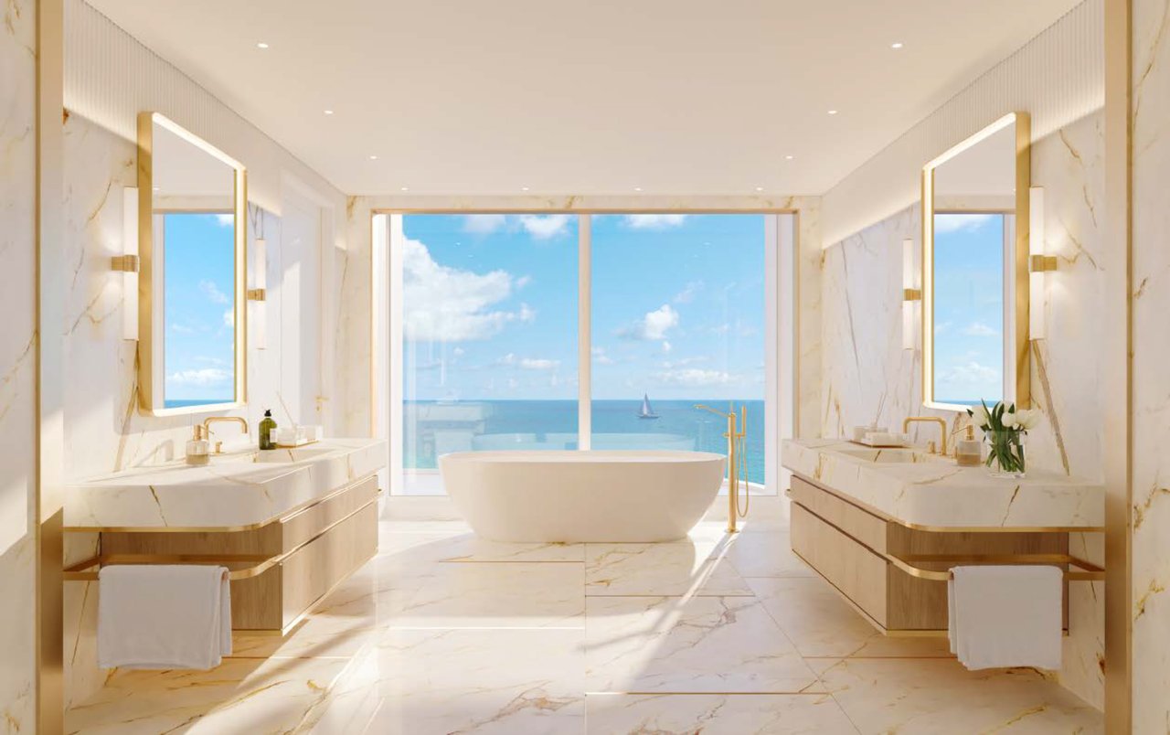 Spa-inspired primary bathroom at The Ritz-Carlton Residences, South Beach with marble finishes, dual vanities, soaking tub, and ocean views.
