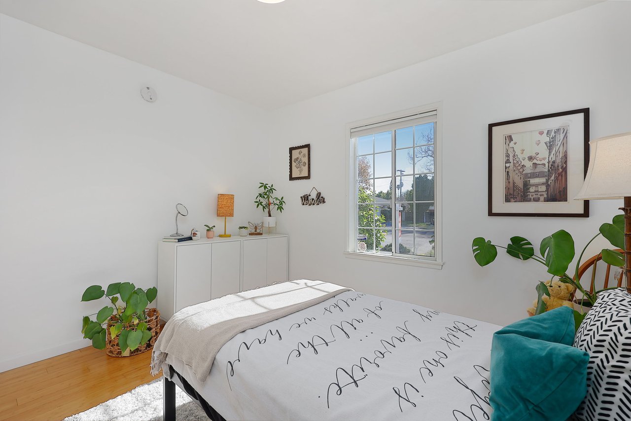 Light-filled bedroom with minimalist decor and outdoor views at 17049 Baltar Street in Lake Balboa CA