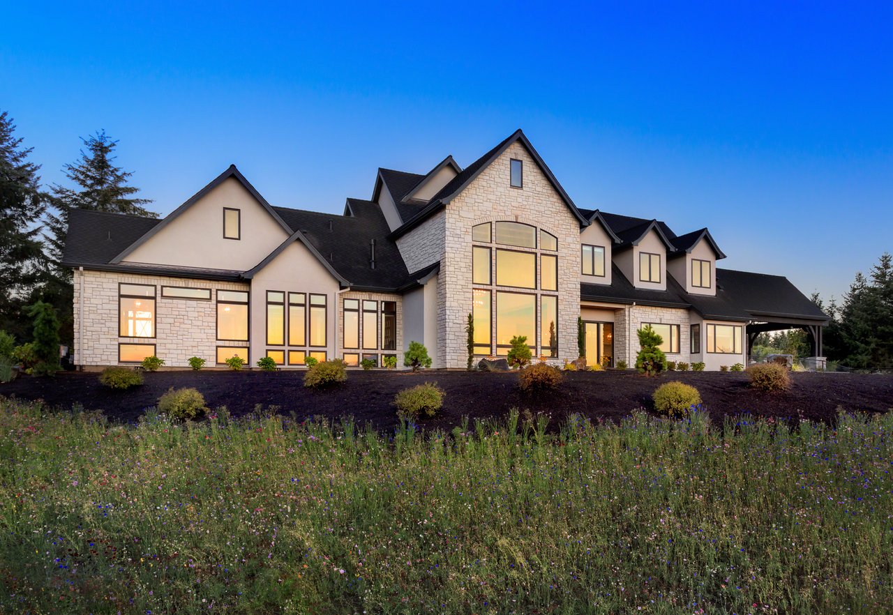 Luxury Texas home exterior at sunset with large windows and modern design