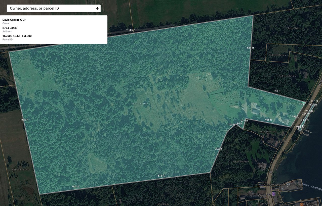 Aerial parcel map outlining a large wooded property with boundary measurements.