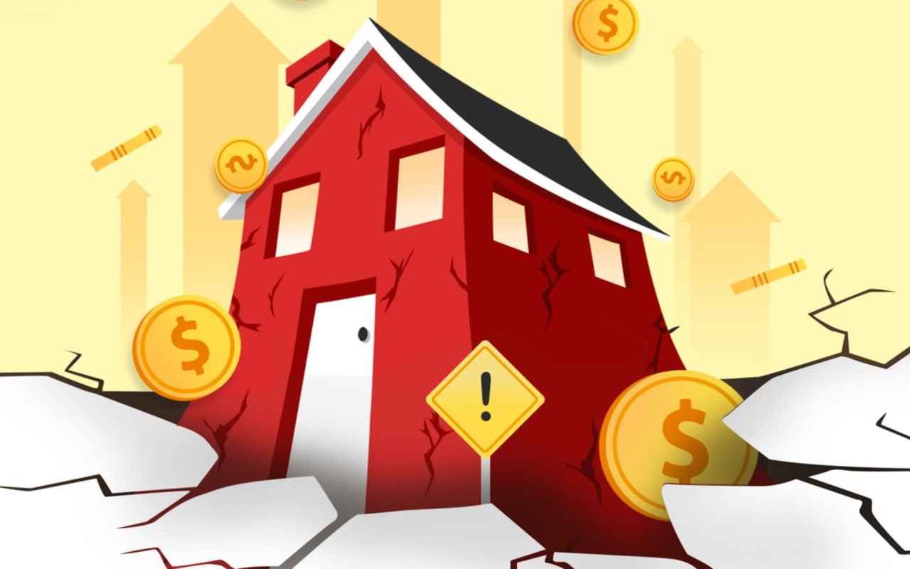 Cracked red fixer-upper house surrounded by dollar coins, broken ground, and a warning sign.