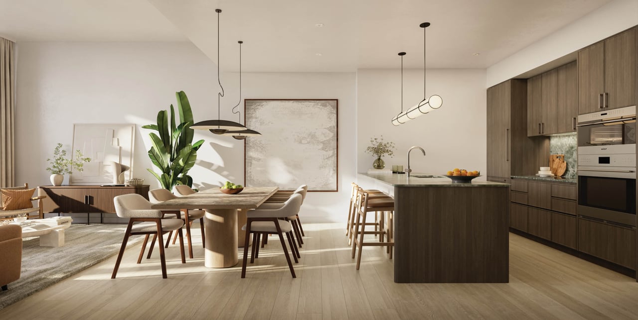 Open-plan kitchen and dining area with a dark wood island, dining table, and pendant lights.