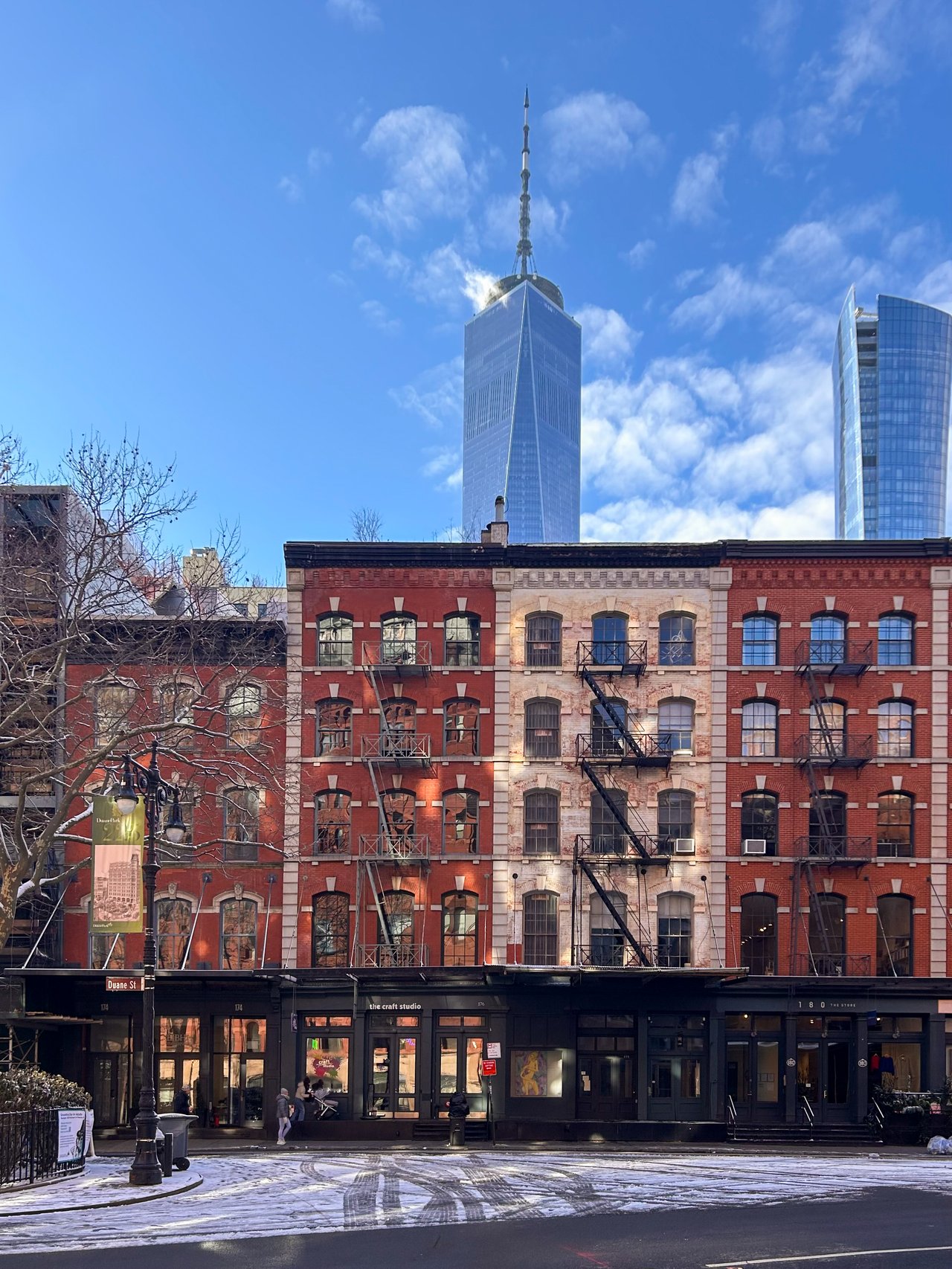 Hands passing a small model house from one person to another.