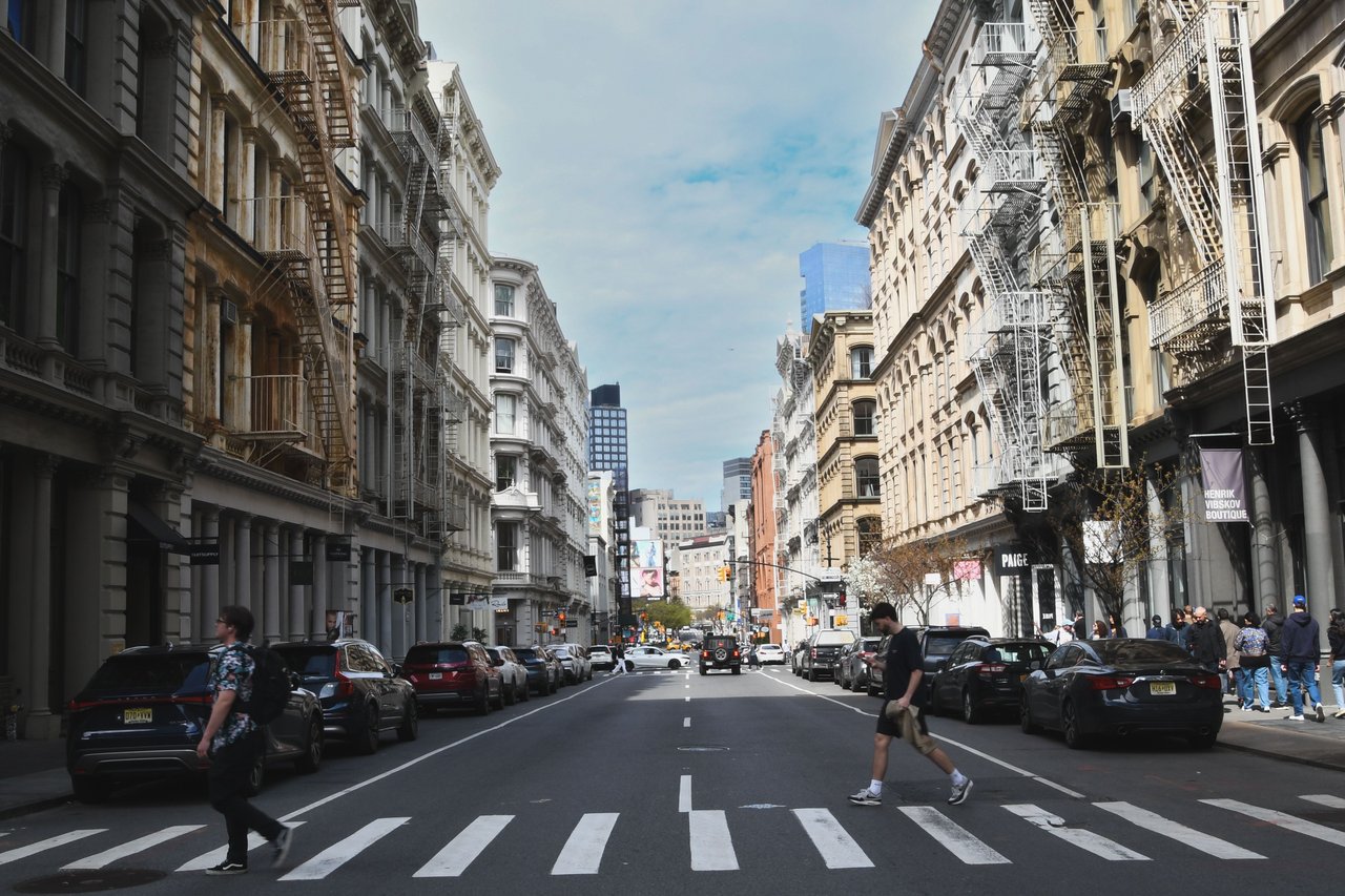 Explore the architectural and urban planning history of Sixth Avenue in SoHo, including its southern extension during the 1920s, the construction of the IND subway, historic masonry buildings, early twentieth-century architecture, and the preservation of the Sullivan-Thompson Historic District.