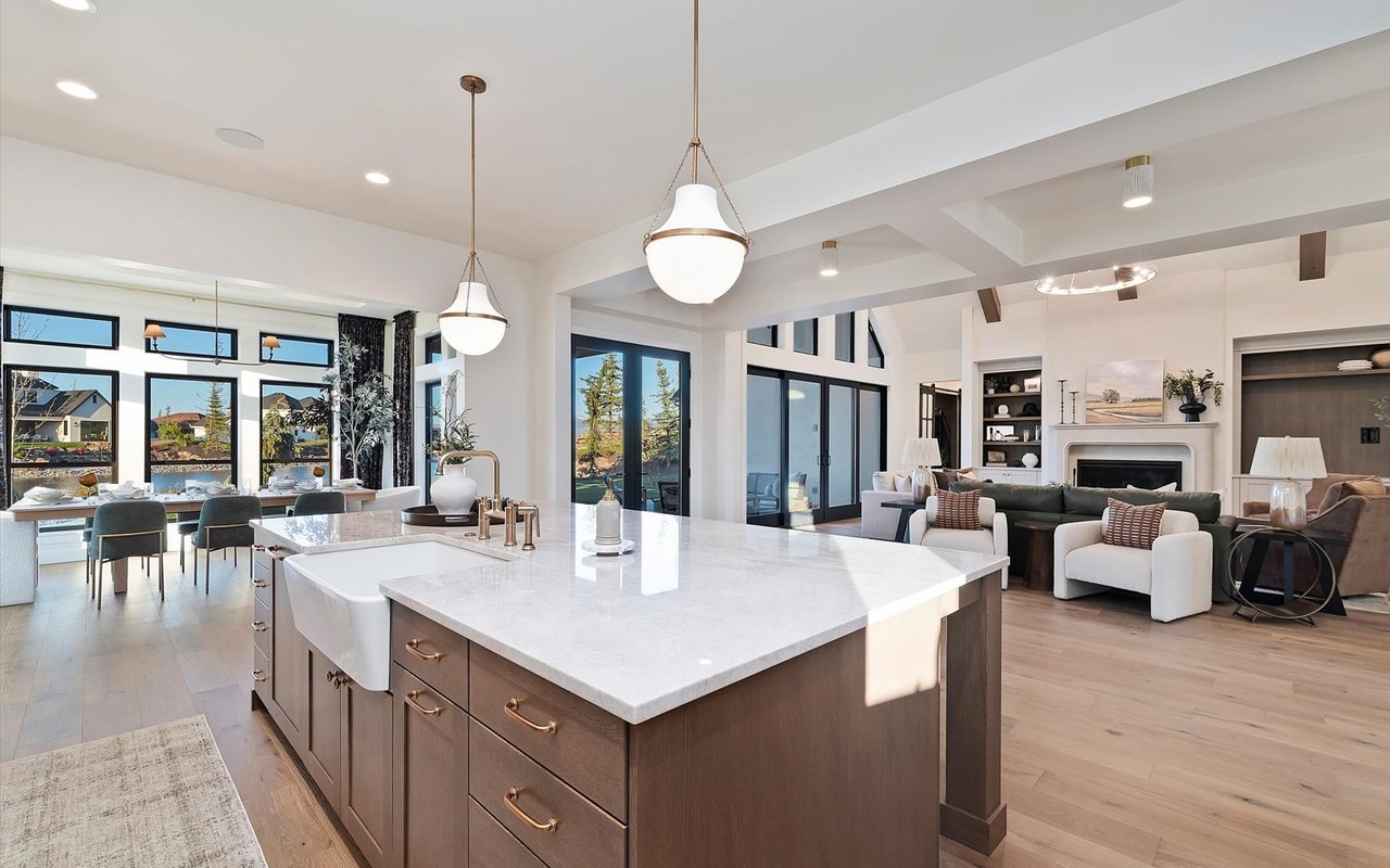 From kitchen island with farmhouse sink looking out to the dining room and living room