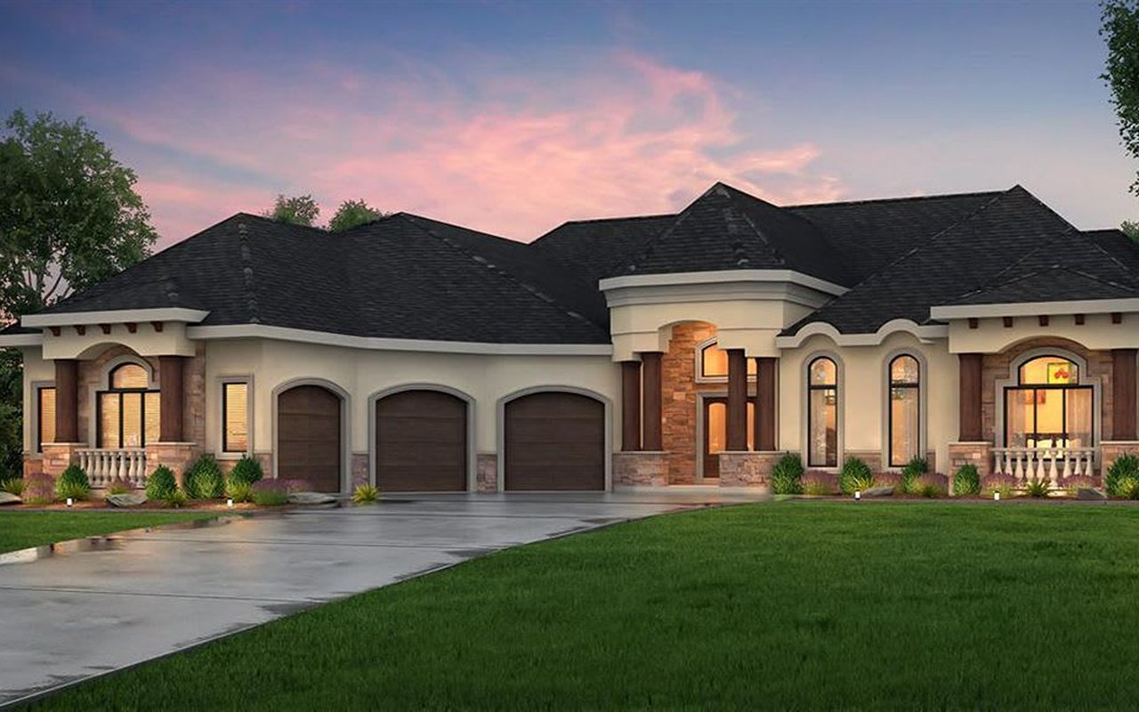Large single-story home with three garage doors, stone accents, and a broad lawn at dusk.