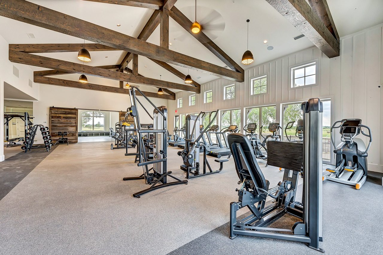 State-of-the-art fitness center with vaulted wood beam ceilings and full