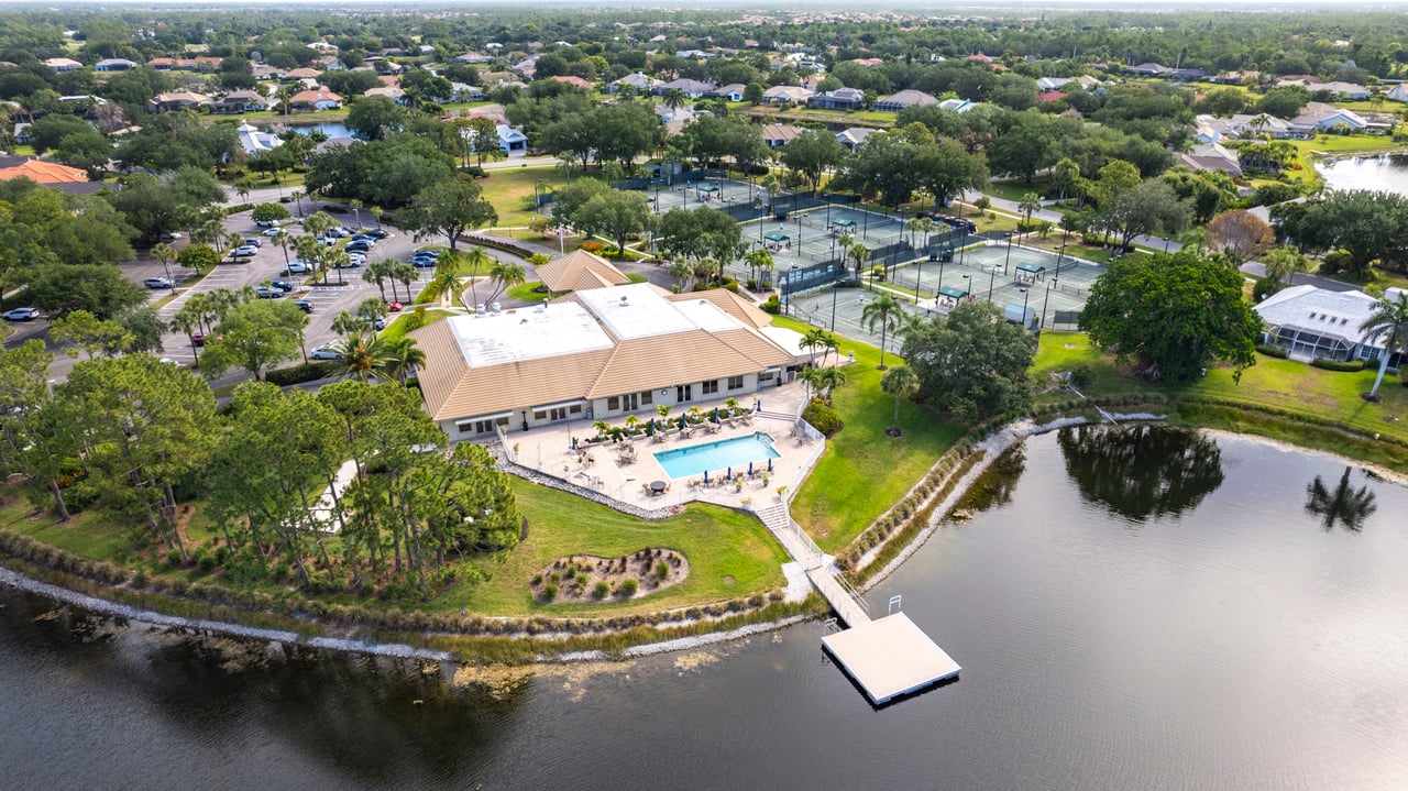 Elevated view of Longshore Lake clubhouse and serene waterfront in Naples FL