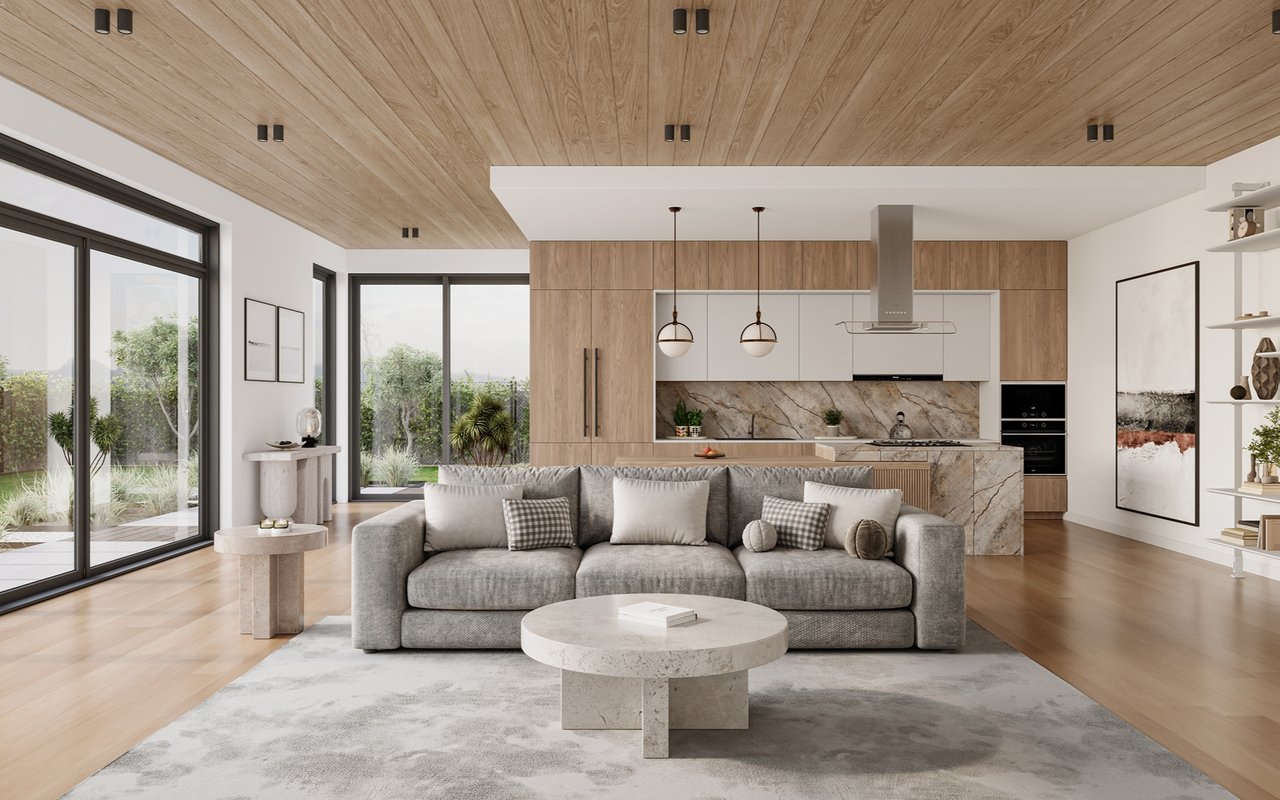 Open-plan living room with gray sofa, pale wood ceiling, marble kitchen backsplash, and garden-facing glass doors.