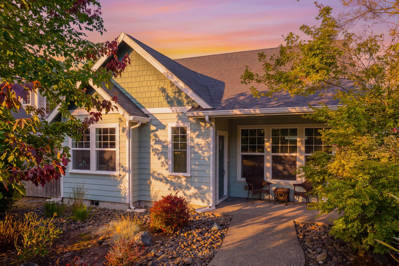 Sold single-level cottage at 10680 Neptune Way in Manzanita, Oregon, listed by Meadow Davis of Home + Sea Realty, with greenbelt views, vaulted ceilings, a covered patio, and transferable short-term rental license.