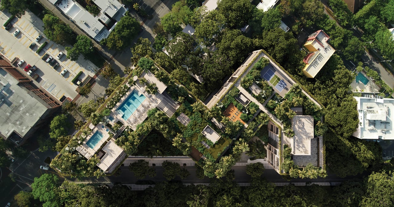 Aerial view of The Well development with landscaped grounds, swimming pools, and rooftop tennis courts.