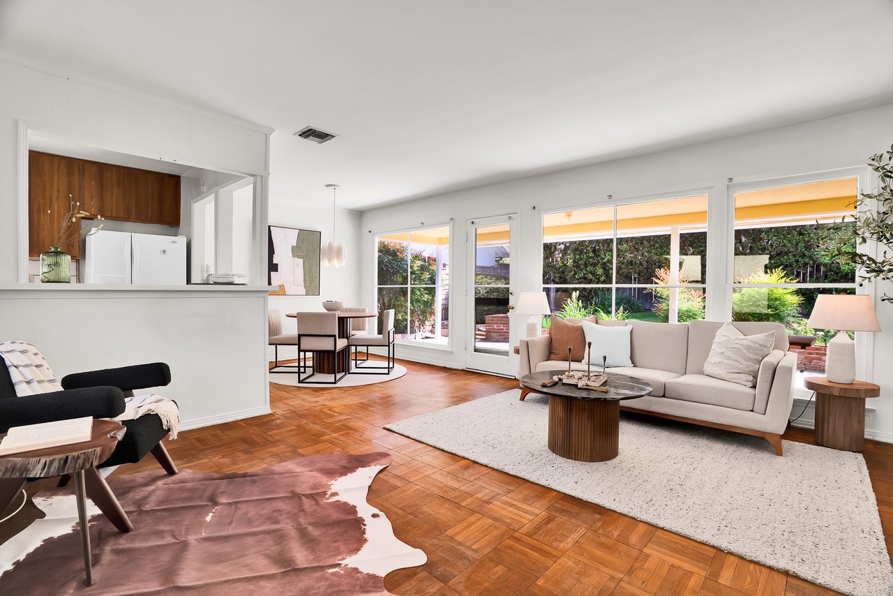 Open concept living room with parquet floors and backyard views at 7862 Jellico Ave, Northridge