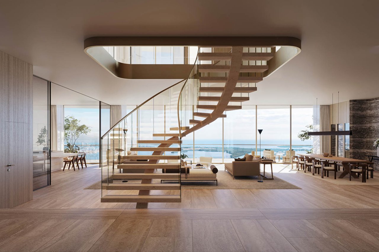 1428 Residences living area with a floating staircase, floor-to-ceiling windows, and water views.