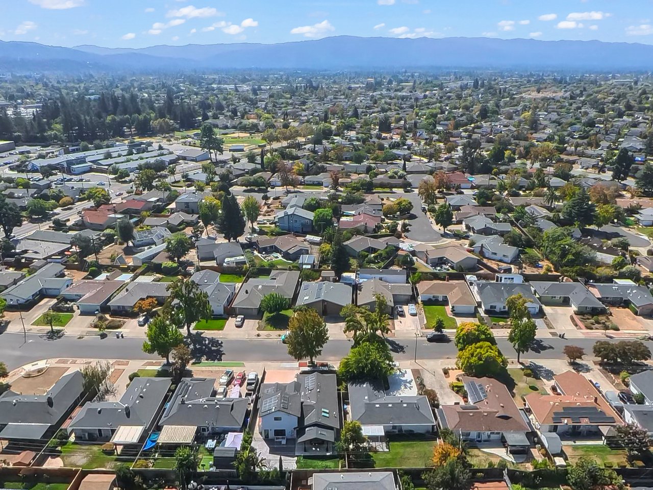 Aerial view of a residential neighborhood with mountains in the distance.