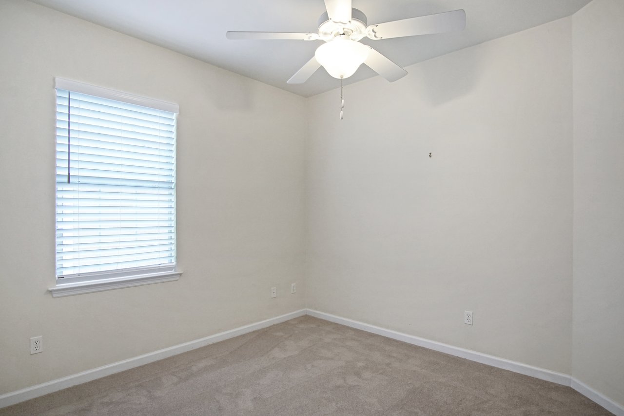 Bedroom at 5441 Hampton Hill Circle, Tallahassee, Florida 32311 with neutral walls, carpet flooring, window blinds, and ceiling fan.