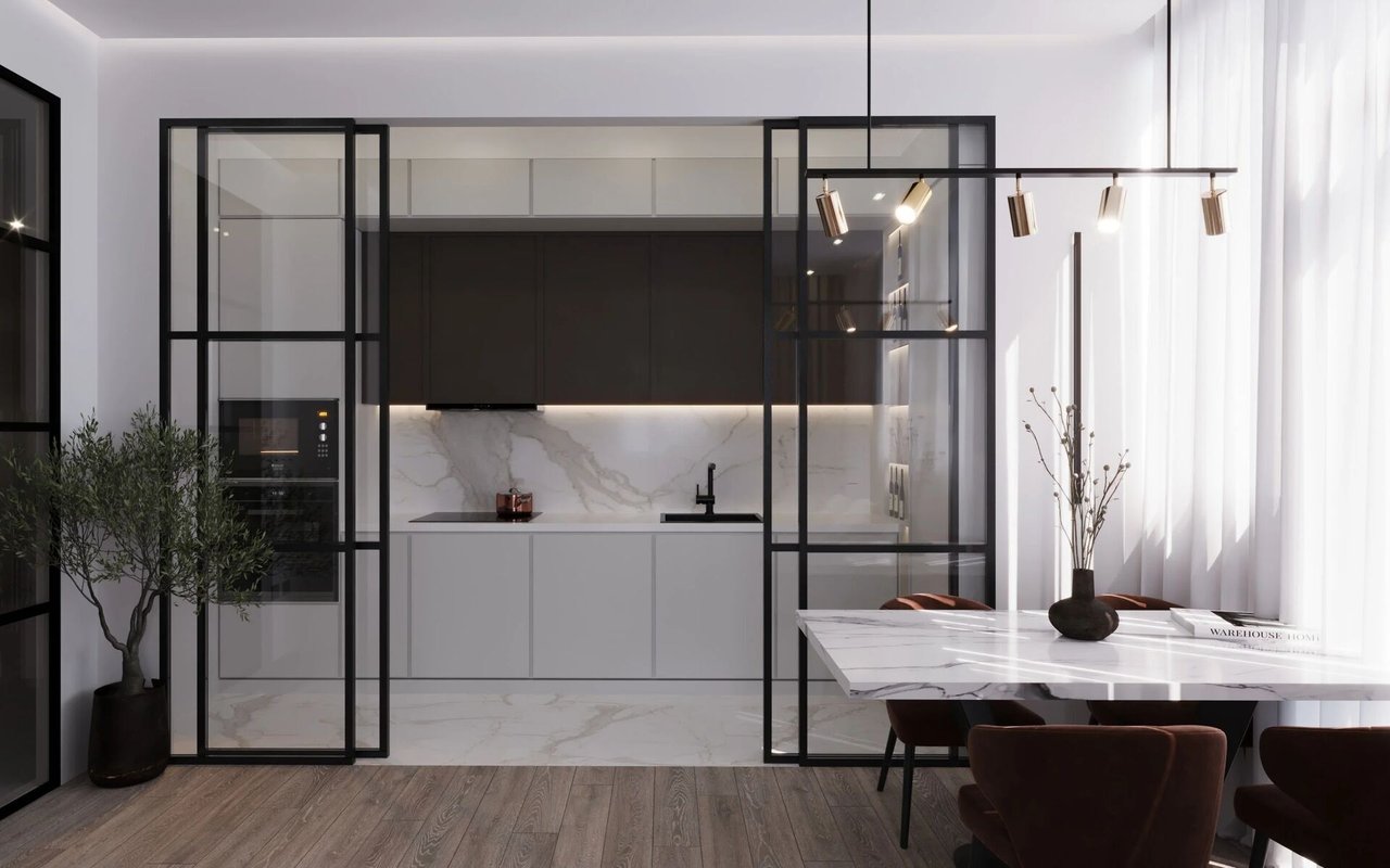 Modern kitchen with dark cabinetry, black-framed glass partitions, and a marble dining table.
