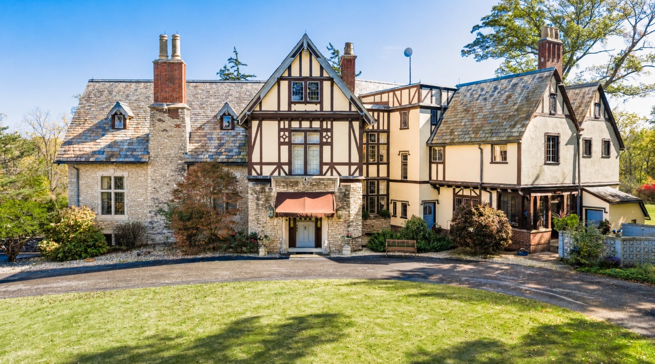 1926 Tudor Revival stone and half-timbered facade of The Hermitage, a historic estate along the Sandusky River in Tiffin, Ohio