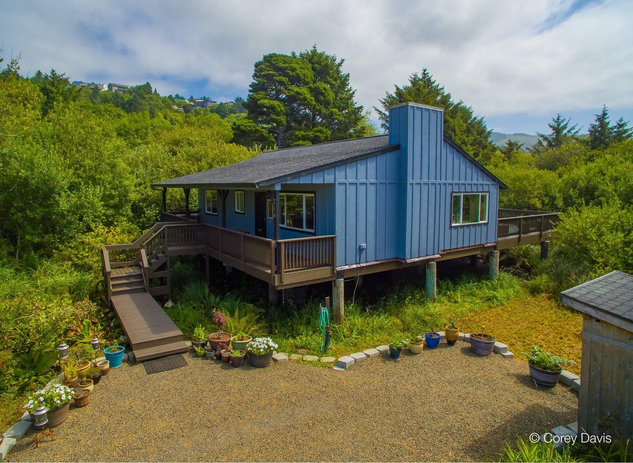 Sold Rockaway Beach cottage at 214 S Fourth Ave represented by Meadow Davis of Home + Sea Realty on a wooded lot near the beach