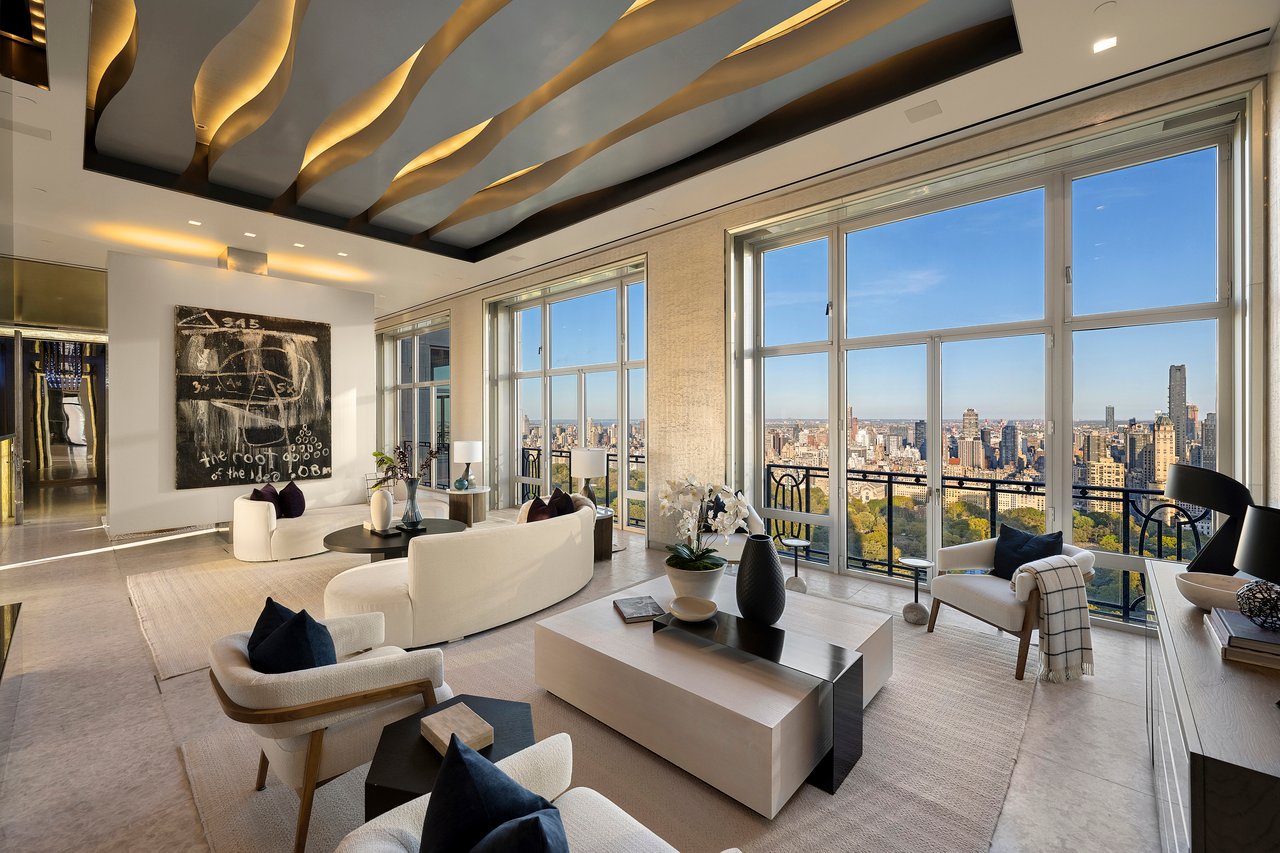 High-rise living room with a sculptural ceiling and floor-to-ceiling windows overlooking the city skyline.