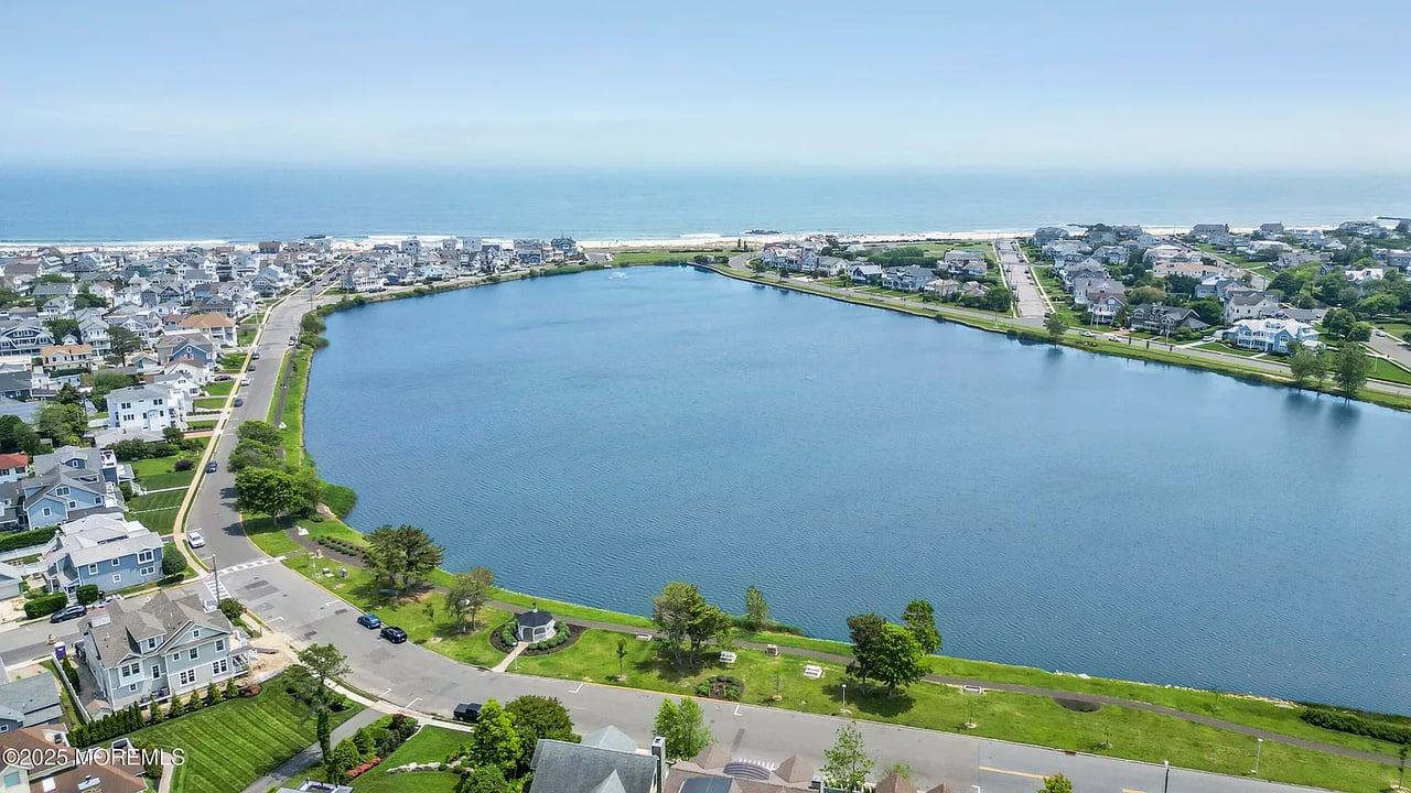 Aerial view of The Villas, with homes around a lagoon and the ocean beyond.