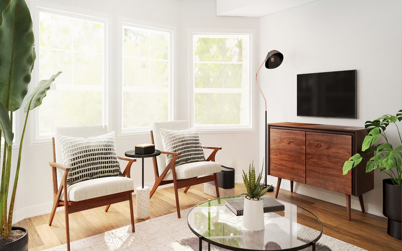  A brightly lit modern living room with large windows that let in natural light, showcasing hardwood floors and white walls.