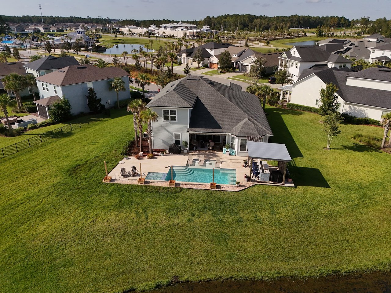 Aerial view of a Silverleaf Village home with a backyard pool and covered patio.