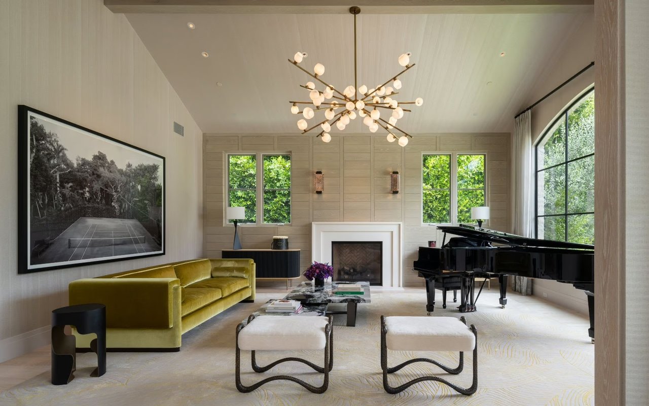 Modern luxury living room with grand piano, velvet sofa, marble coffee table, and large windows