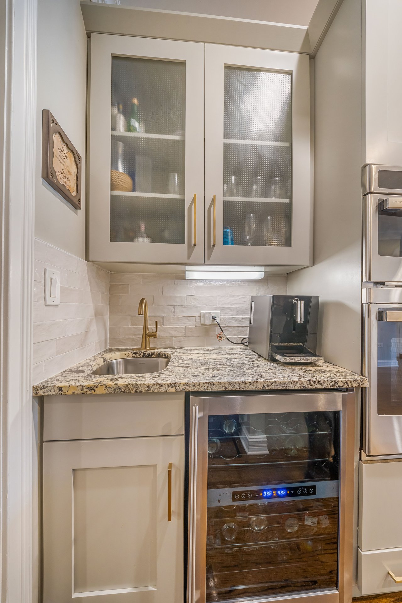 Butler's pantry with glass-front cabinets and wine fridge