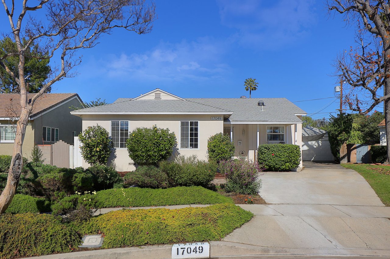 Front exterior of single-story home at 17049 Baltar St in Lake Balboa, showing landscaped yard, driveway, and detached garage
