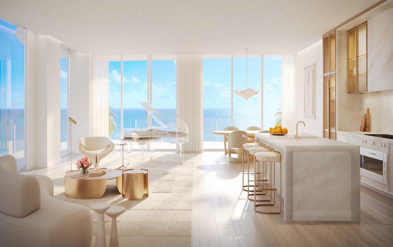 Bright open-concept residence at The Ritz-Carlton Residences, South Beach featuring a marble kitchen island, elegant living area, and direct ocean views.